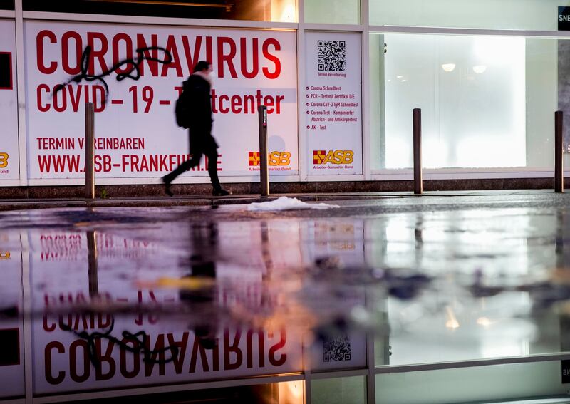 A woman walks past an abandoned coronavirus test centre in Frankfurt. AP Photo