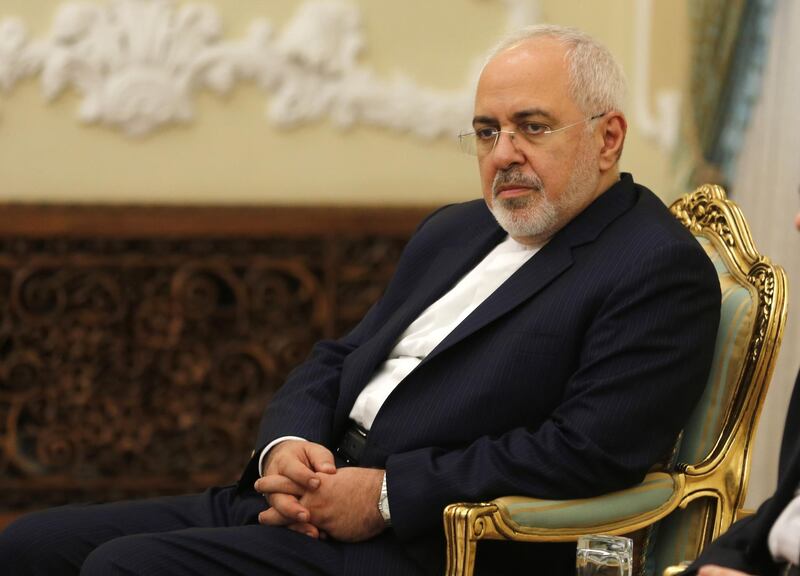 Iran's Foreign Minister Mohammad Javad Zarif listens during Iranian President Hassan Rouhani meeting with North Korea's Foreign Minister Ri Yong Ho in the capital Tehran on August 8, 2018. / AFP PHOTO / ATTA KENARE