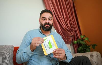 Mustafa Mohammed, 39, holds his package purchased from Aliexpress online shopping store. He waited for 8 months before the package arrived. Majd Mahmoud/The National