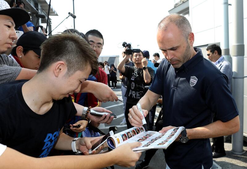 Iniesta signs his autograph for Japanese fans upon his arrival at Kansai International Airport. Jiji Press / EPA
