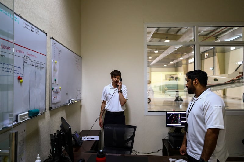 Pilots Michael Anstis and Ahmed Al Jaberi receive instructions before the flight.