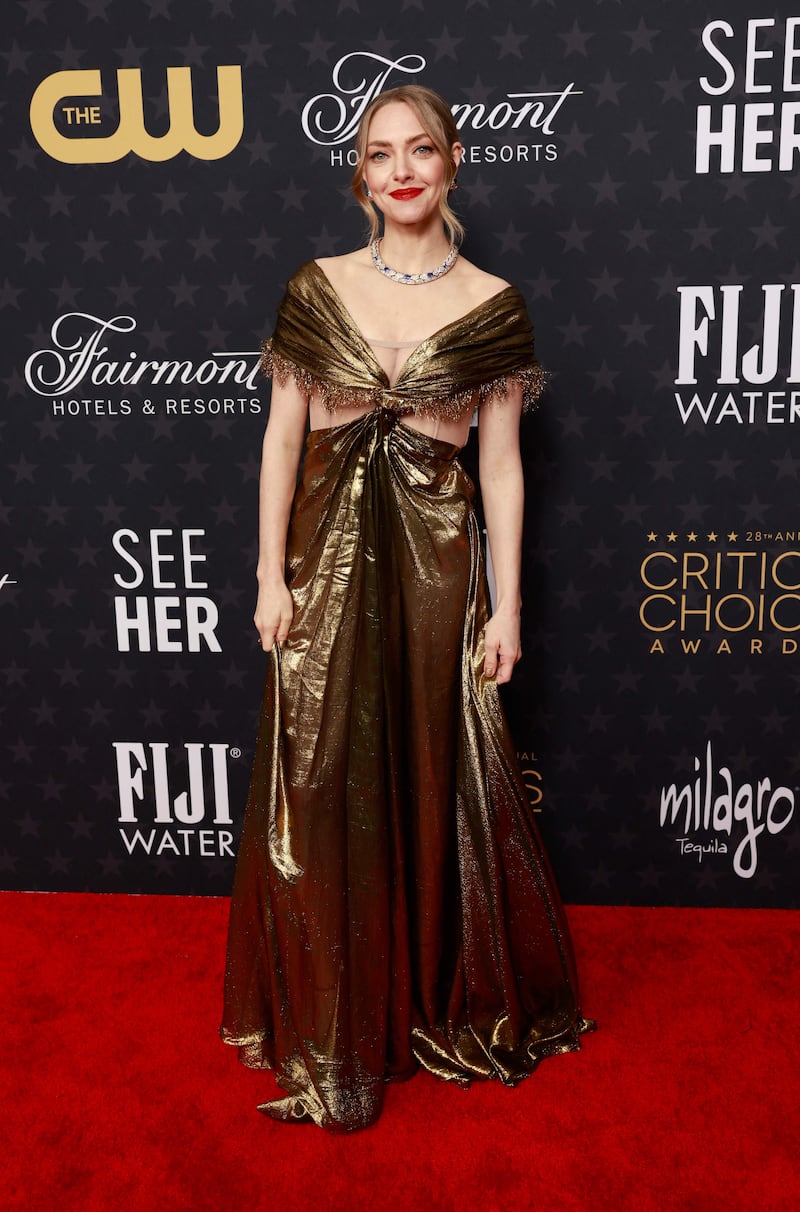 Amanda Seyfried in a metallic gold Dior Haute Couture dress. AFP