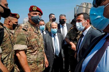 Lebanon's President Michel Aoun (C) wears a protective face mask as he visits the site of a massive explosion the previous day in the heart of the Lebanese Beirut on August 5, 2020. / AFP / -