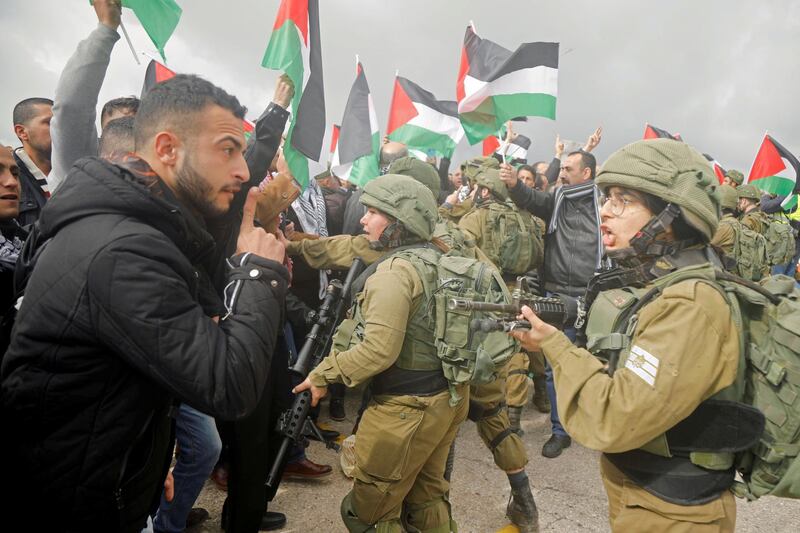 A Palestinian demonstrator argues with Israeli forces during a protest in Jordan Valley in the Israeli-occupied West Bank January 29, 2020. Reuters