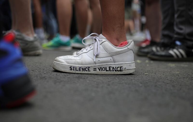 A demonstrator displays a message of protest on shoes as protesters rally against the death in Minneapolis police custody of George Floyd, near the White House in Washington, U.S. REUTERS