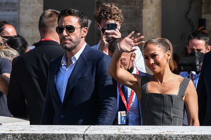 Is Lopez waving or hailing a water taxi for Affleck in Venice? AFP