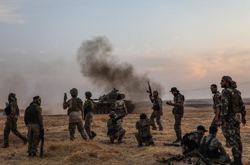 Turkish soldiers and Turkey-backed Syrian fighters gather on the northern outskirts of the Syrian city of Manbij near the Turkish border, as Turkey and its allies continue their assault on Kurdish-held border towns in northeastern Syria. Turkey wants to create a roughly 30-kilometre (20-mile) buffer zone along its border to keep Kurdish forces at bay and also to send back some of the 3.6 million Syrian refugees it hosts. AFP