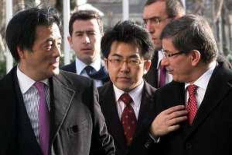 Turkey's Foreign Minister Ahmet Davutoglu (R) and Japan's Foreign Minister Katsuya Okada (L) pose before a meeting in Ankara on January 4, 2010. AFP PHOTO/ADEM ALTAN *** Local Caption ***  552111-01-08.jpg *** Local Caption ***  552111-01-08.jpg