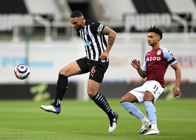 NEWCASTLE UPON TYNE, ENGLAND - MARCH 12: Jamaal Lascelles of Newcastle United battles for possession with Ollie Watkins of Aston Villa during the Premier League match between Newcastle United and Aston Villa at St. James Park on March 12, 2021 in Newcastle upon Tyne, England. Sporting stadiums around the UK remain under strict restrictions due to the Coronavirus Pandemic as Government social distancing laws prohibit fans inside venues resulting in games being played behind closed doors. (Photo by Clive Brunskill/Getty Images)