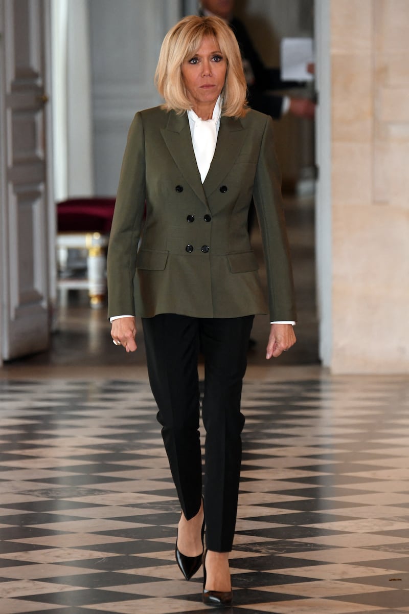 Brigitte, wearing a khaki Louis Vuitton blazer, visits the Chateau de Versailles on November 11, 2018. AFP