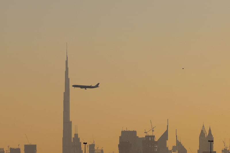 A commercial airplane flies past Burj Khalifa. The UAE's economy grew by 3.8 per cent on an annual basis in the first quarter of this year. AFP