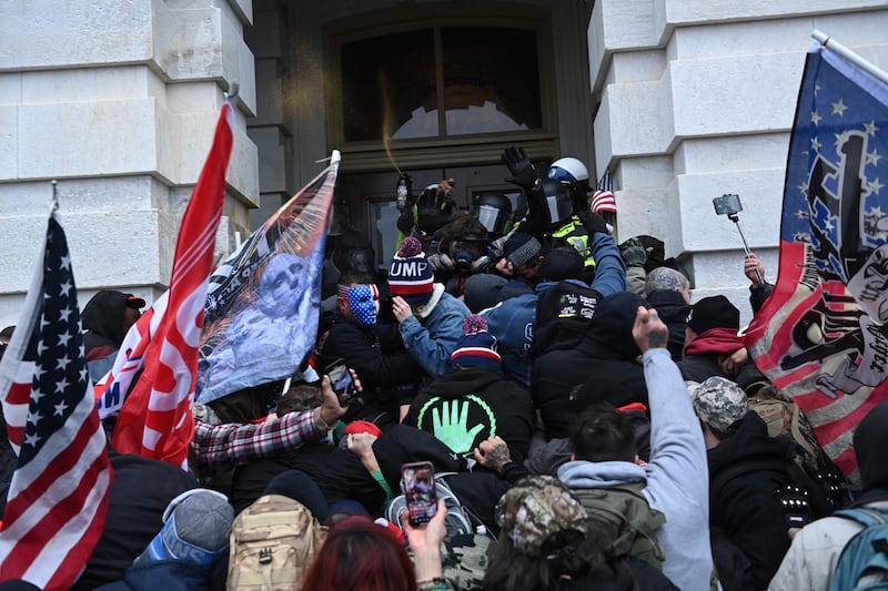 Trump supporters clash with police and security forces as they storm the US Capitol in Washington, DC. AFP