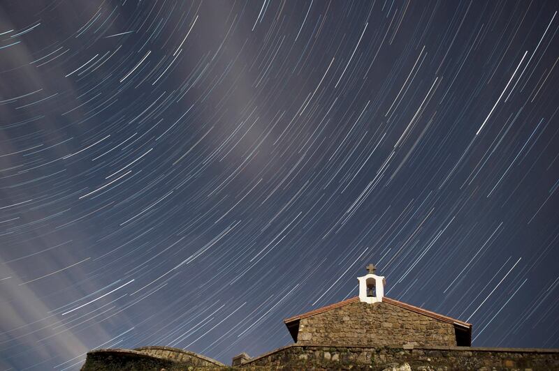 A multiple exposure image shows the sky during the Quadrantis meteor shower above Saint Esteban chapel in Comillas, Cantabria, northern Spain. Pedro Puente Hoyos / EPA