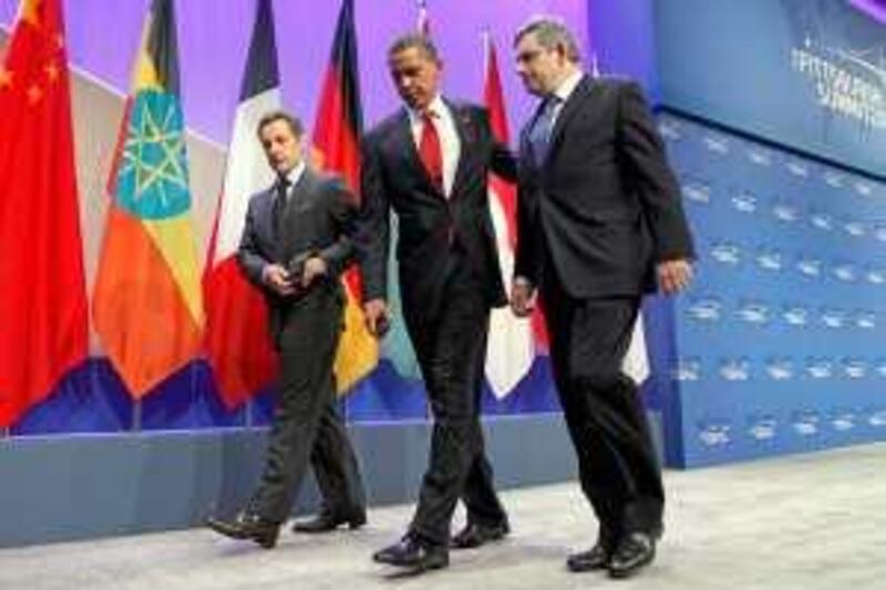 President Barack Obama, center, British Prime Minister Gordon Brown, right, and French President Nicolas Sarkozy leave the stage after making a joint statement on Iran's nuclear facility, Friday, Sept. 25, 2009,  during the G-20 Summit in Pittsburgh. (AP Photo/Charles Dharapak) *** Local Caption ***  PADA106_APTOPIX_G20_Summit_Iran.jpg *** Local Caption ***  PADA106_APTOPIX_G20_Summit_Iran.jpg