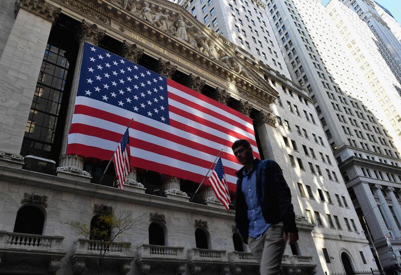 (FILES) In this file photo a person walks past the New York Stock Exchange (NYSE) at Wall Street on November 16, 2020 in New York City. Wall Street stocks were modestly higher early January 5, 2021 as markets monitored worsening coronavirus trends around the United States and elections in Georgia that will determine control of the Senate. Investors remain on watch for additional Covid-19 restrictions in the US after Britain on Monday announced a new national lockdown.
 / AFP / Angela Weiss
