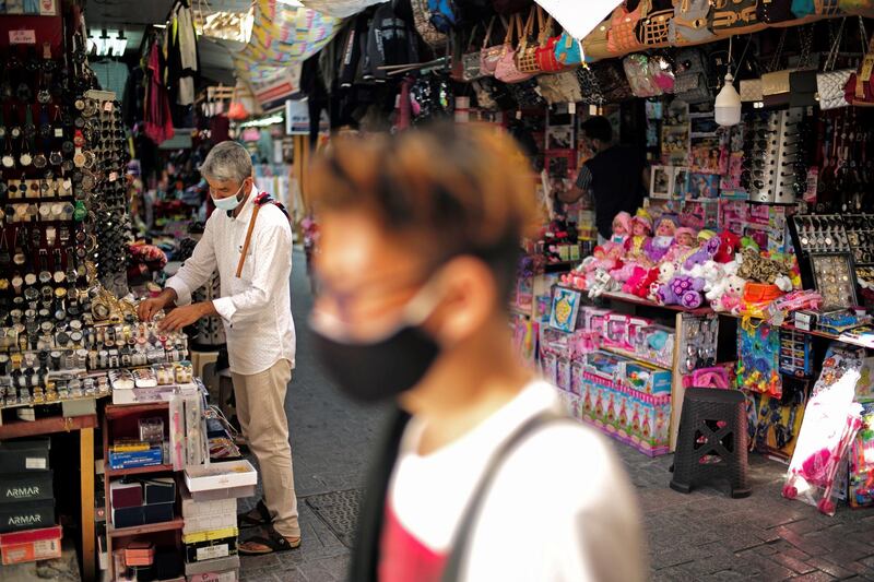 A salesman wearing a face mask, displays his goods after opening his shop in a traditional market "Local Souq", following the outbreak of the Coronavirus disease (COVID-19), in Manama, Bahrain, October 30, 2020. REUTERS/Hamad I Mohammed