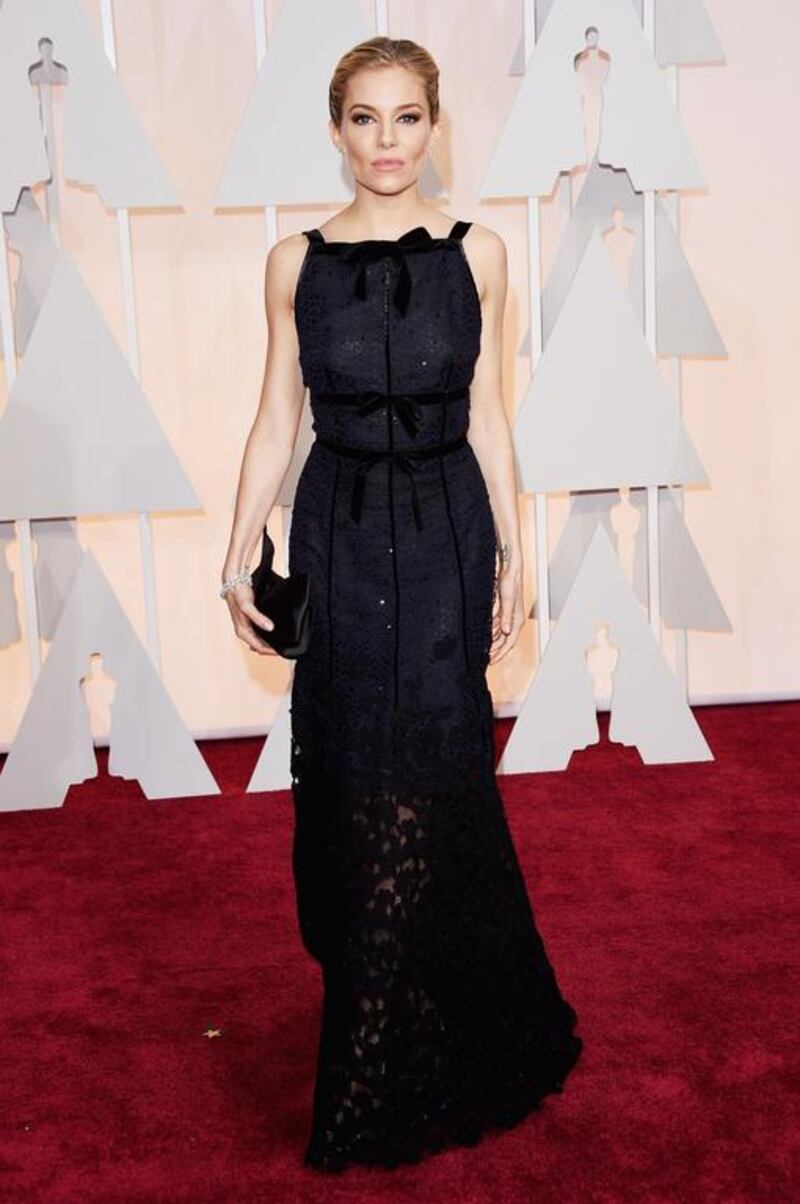 The seriously slimmed-down Sienna Miller wore a black and navy, Oscar de la Renta dress. With a striking apron neckline and a mix of velvet and lace, the ensemble was almost ruined by her excessive contouring and heavy eye make-up. Jason Merritt / Getty Images / AFP