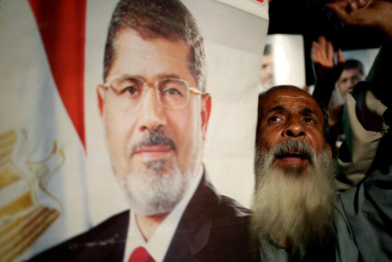 Supporters of Egypt's ousted President Mohammed Morsi chant slogans against Egyptian Defense Minister Gen. Abdel-Fattah el-Sissi at Nasr City, where protesters have installed a camp and hold daily rallies, in Cairo, Egypt, Sunday, July 28, 2013. Deadly clashes broke out during funerals of slain supporters of Egypt's ousted Islamist president Sunday, as the supreme leader of the Muslim Brotherhood urged his followers to stand fast after more than 80 of them were killed in weekend violence. (AP Photo/Hassan Ammar) *** Local Caption ***  APTOPIX Mideast Egypt.JPEG-0727c.jpg