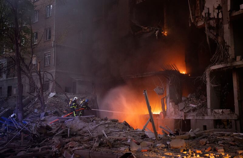 Firefighters try to put out a blaze after an explosion in Kyiv as Russia mounts attacks across Ukraine. AP