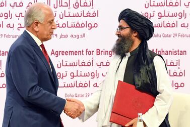 US Special Representative for Afghanistan Reconciliation Zalmay Khalilzad and Taliban co-founder Mullah Abdul Ghani Baradar shake hands during the signing ceremony of the US-Taliban peace agreement in Doha, Qatar. EPA