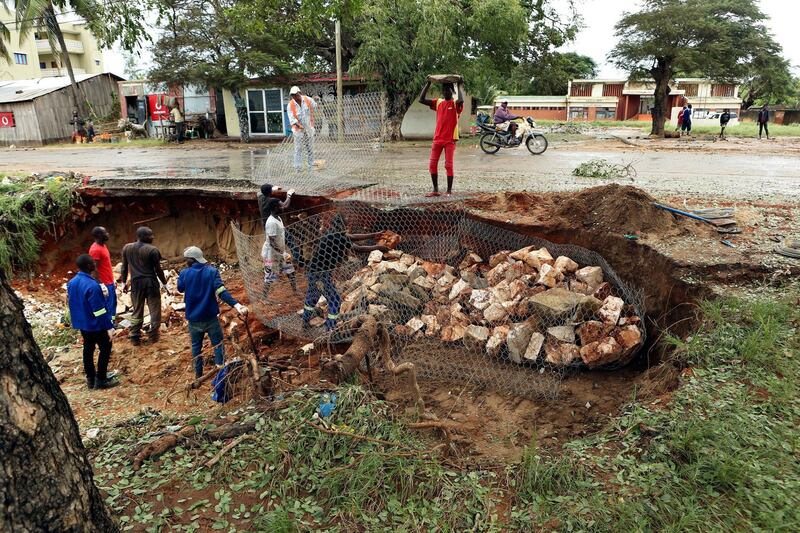 Men repair a road damaged by Cyclone Kenneth in Pemba city on the northeastern coast of Mozambique.  Cyclone Kenneth arrived late Thursday, just six weeks after Cyclone Idai ripped into central Mozambique and killed more than 600 people. AP