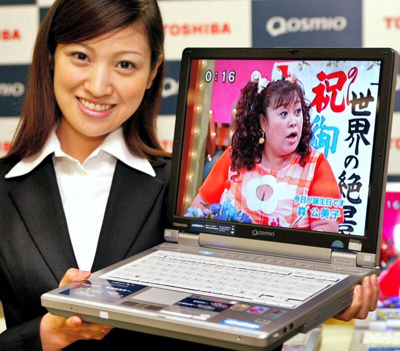Japan's electronics giant Toshiba unveils its new laptop computer "Qosmio" at the company's headquarters in Tokyo, 22 July 2004.  The "Qosmio" is equipped with a 1.5 GHz Intel Pentium M processor, a 15-inch XGA LCD display and a global TV tuner which enables it to works under NTSC, PAL or SECAM signal.  Toshiba will release the "Qosmio" 06 August at an estimated price of 260,000 yen (2,400 USD).           AFP PHOTO/Yoshikazu TSUNO (Photo by YOSHIKAZU TSUNO / AFP)