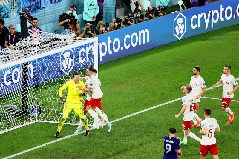 Poland players congratulate Wojciech Szczesny after he saved a Lionel Messi penalty. Getty