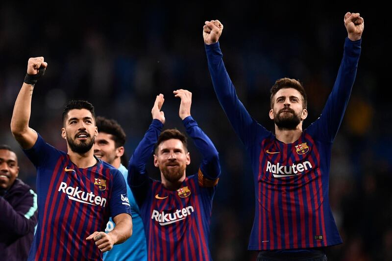 Barcelona's Luis Suarez, left, Lionel Messi, centre, and Gerard Pique celebrate their win at Real Madrid. AFP