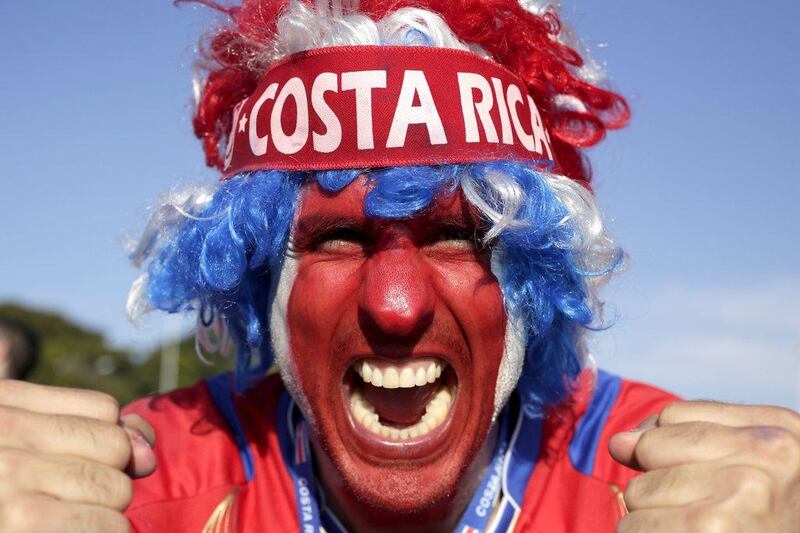 A supporter celebrates Costa Rica's classification at the end of the World Cup group D match against England, at the Mineirao Stadium, in Belo Horizonte, Brazil, Tuesday, June 24, 2014. Costa Rica finished first in what many considered the World Cup's toughest group after a dour 0-0 draw against England. AP Photo/Bruno Magalhaes