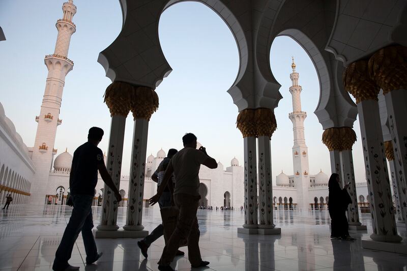 ABU DHABI, UNITED ARAB EMIRATES, Oct. 2, 2014:  
Admiring the beauty of the structure, tourists and locals stream through the arched walkways of the Sheikh Zayed Grand Mosque on Thursday evening, Oct. 2, 2014, a day before Eid al Adha begins. (Silvia Razgova / The National)

Usage: Oct. 2, 2014
Section: NA
Reporter:  standalone

