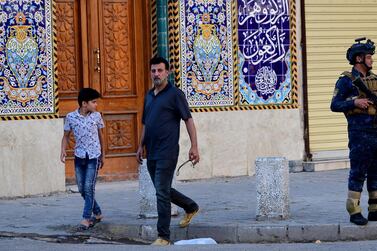 A member of Iraqi federal police forces stands guard in front of a Shiite Mosque in Baghdad's Karada district. EPA