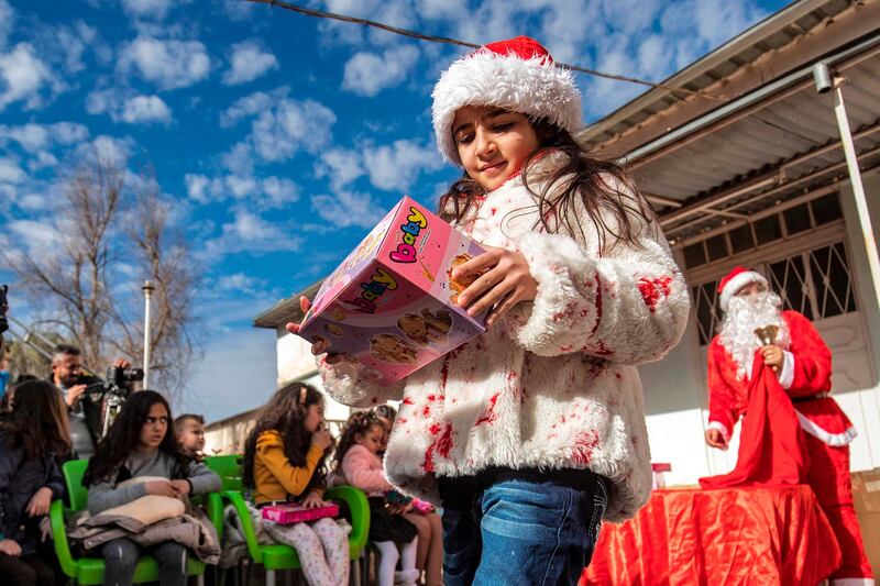 Children attend a Christmas celebration event by Syriac Christians in the town of al-Qahtaniyah in Syria's north-eastern Hasakeh province near the Turkish border. AFP
