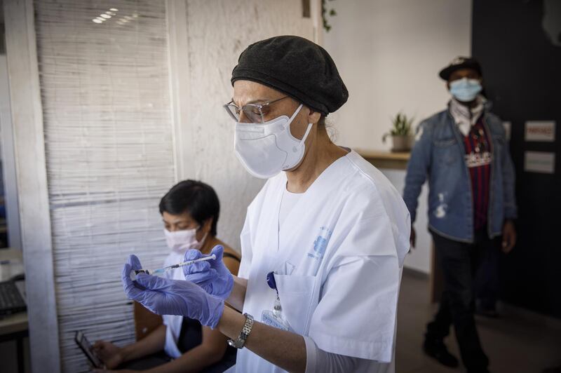 A nurse prepares a dose of the Pfizer-BioNTech Covid-19 vaccine for administration to a foreign national at a vaccination centre in Tel Aviv. Bloomberg