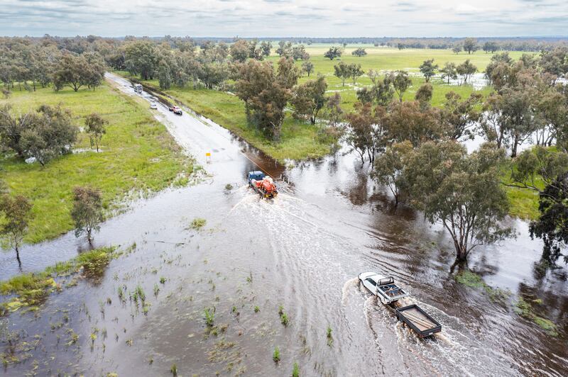 Vehicles negotiate floodwater from the Bundaburrah Creek on the Henry Lawson Way in New South Wales, Australia.  Rains have eased but New South Wales is still on high alert with another rain onslaught to hit the state which has already seen repeated flood events. EPA