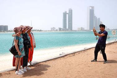 Chinese tourists enjoy the sights at the Heritage Village, Corniche. There has been a drive to improve the experience of tourists with the UAE listed as among the most favoured spots in the world for visitors from China. Victor Besa/The National 
