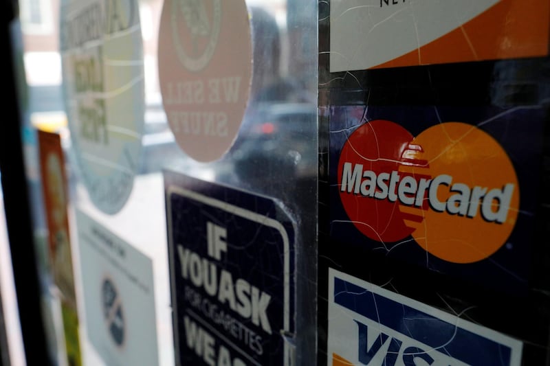 A sticker shows that a store accepts MasterCard in Harvard Square in Cambridge, Massachusetts, U.S., July 25, 2018.   REUTERS/Brian Snyder