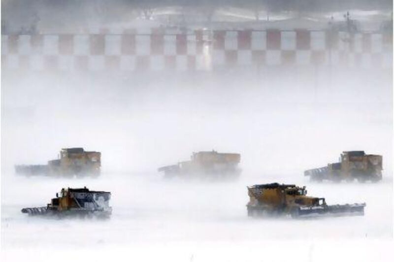 Snow removal crews work to clear runways at Philadelphia International Airport.