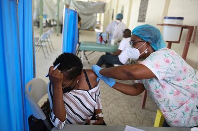 A health worker injects a person with a dose of the Moderna Covid-19 vaccine donated through the Covax initiative in Port-au-Prince, Haiti. Photo: AP