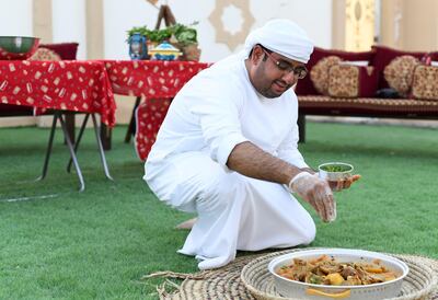 Abu Dhabi, United Arab Emirates - Ali Al Neyadi garnishes the dish of Thareed. Khushnum Bhandari for The National