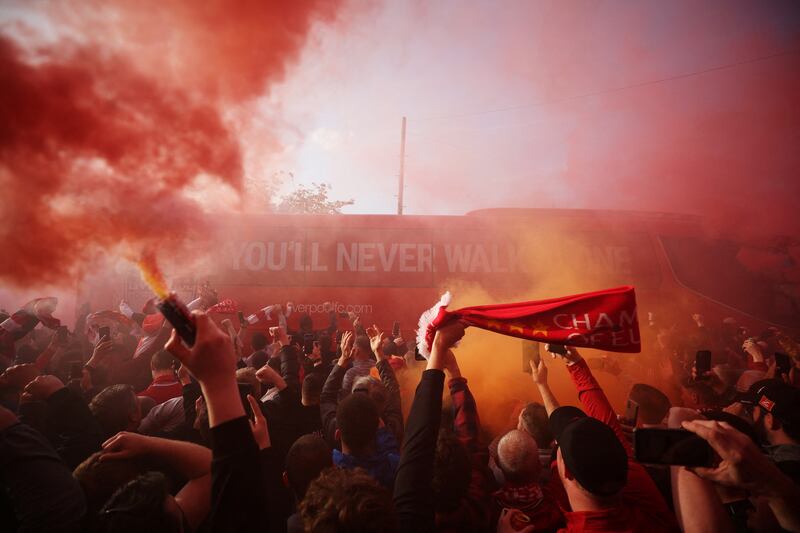 Liverpool fans set off flares outside Anfield football stadium as the football team’s coach arrives before the match against Villarreal of Spain. Reuters