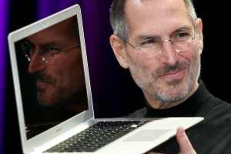 (FILES) Apple CEO and co-founder Steve Jobs shows off the new Macbook Air ultra portable laptop during his keynote speech at the MacWorld Conference & Expo in San Francisco in this January 15, 2008 file photo. Jobs, in his first statement since taking a medical leave of absence in January, announced on June 22, 2009 that the company has sold more than one million of its new iPhone model in three days. "Customers are voting and the iPhone is winning," Jobs said in a written statement. He said over one million iPhone 3GS models had been sold through Sunday and six million customers have downloaded the new iPhone 3.0 software in the first five days since its release. AFP PHOTO/Tony AVELAR/FILES *** Local Caption ***  242713-01-08.jpg