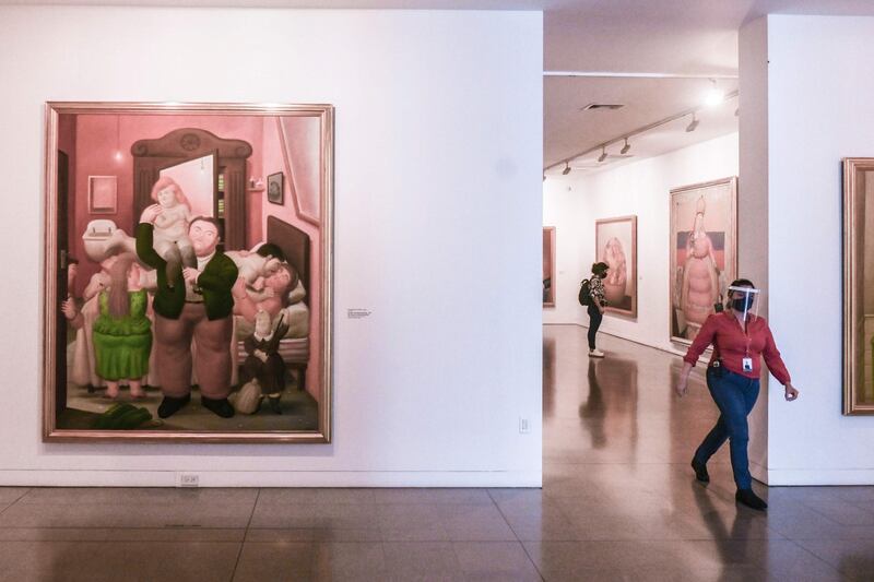 A guide walks by paintings by Colombian artist Fernando Botero at the Museum of Antioquia in Medellin, Colombia. AFP