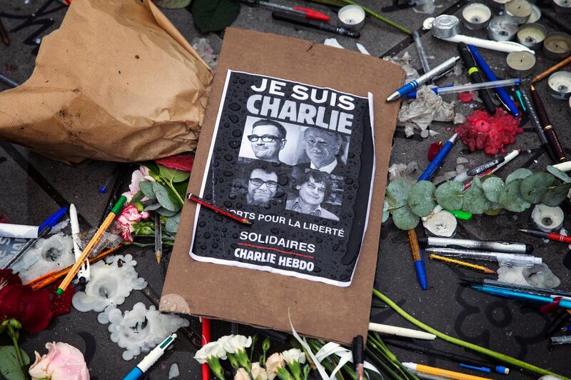 epa07242945 A poster reads 'Je suis Charlie' (I am Charlie) amid symbolic pens and pencils on Place de la Republique as people gather for a minute of silence commemorating those killed in a shooting at French satirical magazine 'Charlie Hebdo', in Paris, France, 08 January 2015 (reissued 21 December 2018). According to local media, French authorities have taken a suspected jihadi, linked to the men who attacked the Charlie Hebdo headquarters, in to custody in Paris.  EPA/ETIENNE LAURENT