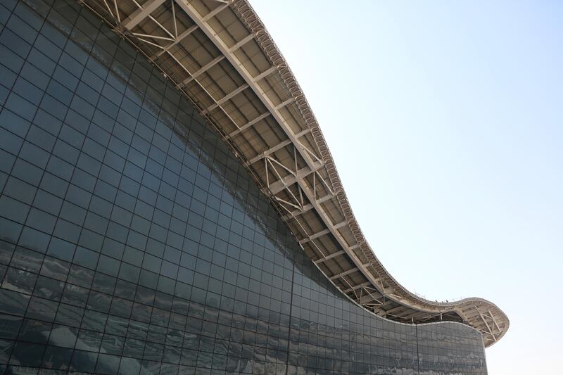 A curved roof sits above a glass wall structure at Abu Dhabi airport's Midfield terminal. Natalie Naccache / Bloomberg