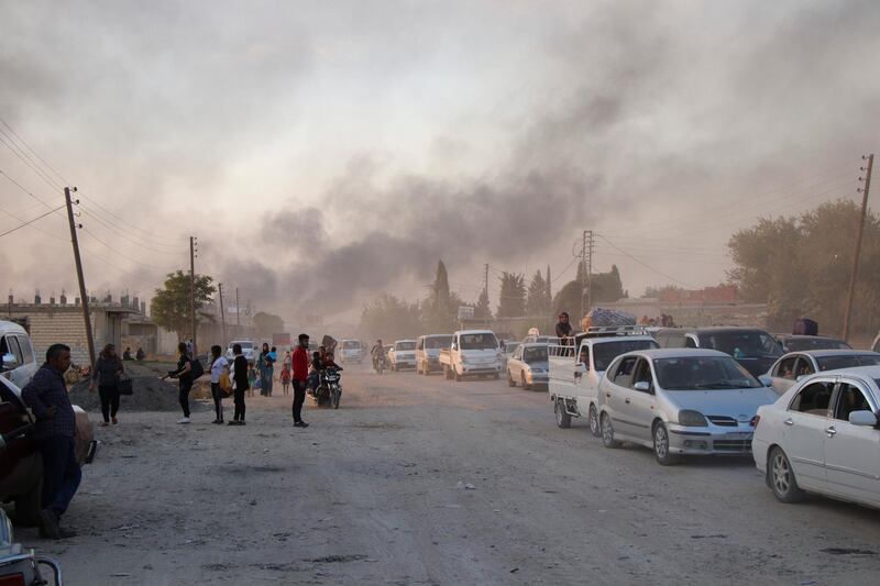 Syrians flee shelling by Turkish forces in Ras Al Ain, northeast Syria. AP Photo