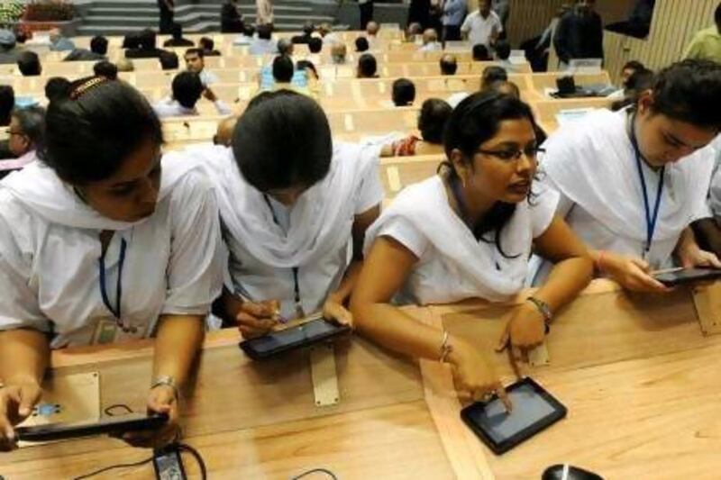 India has demonstrated impressive achievements in the digital arena. Above, Indian students use the newly launched "Akash", its long-awaited "computer for the masses". Prakash Singh / AFP