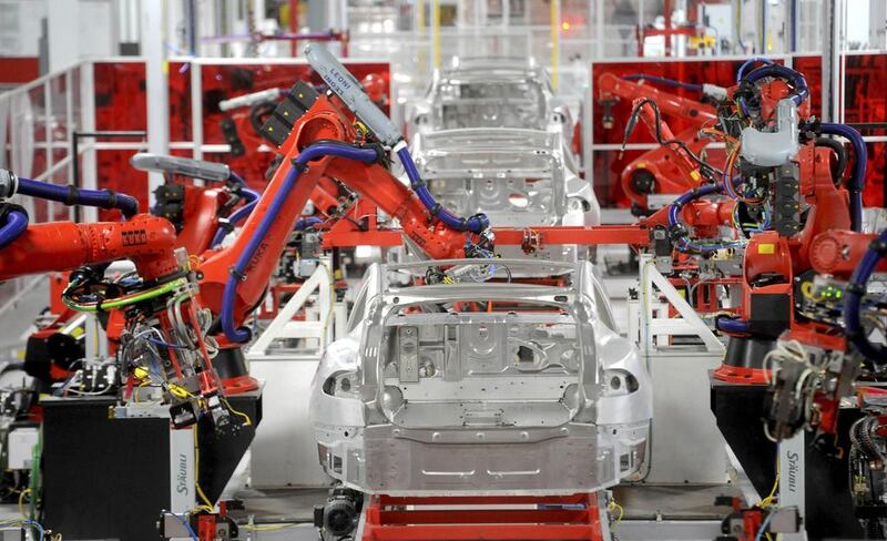 Robotic arms assemble Tesla’s Model S sedans at the company’s factory. Noah Berger / Reuters
