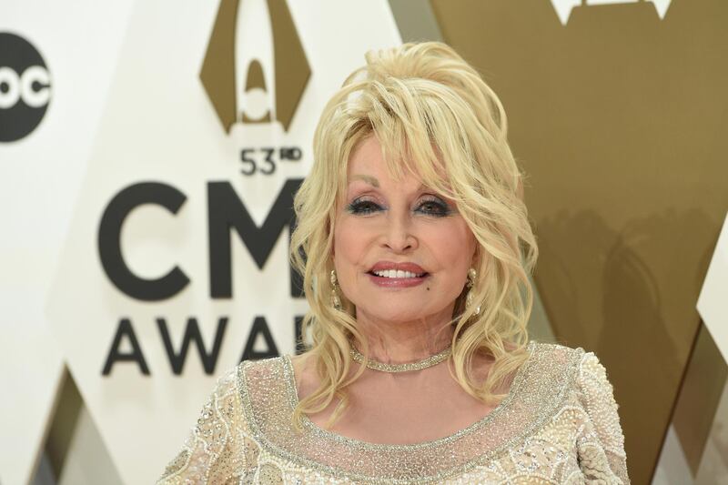 File-This Nov. 13, 2019, file photo shows Dolly Parton arriving at the 53rd annual CMA Awards at Bridgestone Arena in Nashville, Tenn. Parton's new Netflix series "Heartstrings" will tell a host of stories when it premieres on Friday. One will put the spotlight on Parton's home and people in the mountains of East Tennessee. The series debuts on the streaming platform with eight episodes each telling a story based on one of Parton's songs.(Photo by Evan Agostini/Invision/AP, File)