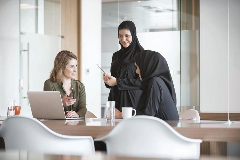 A photo of multi-ethnic businesswomen discussing in modern office in the Middle East. Multiracial Arab and Caucasian professional women are at conference table in modern middle eastern workplace. Getty Images