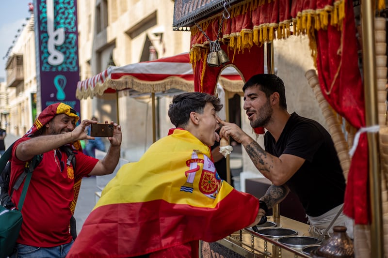 A Spain fan is given a treat by an ice cream seller at Souq Waqif. EPA